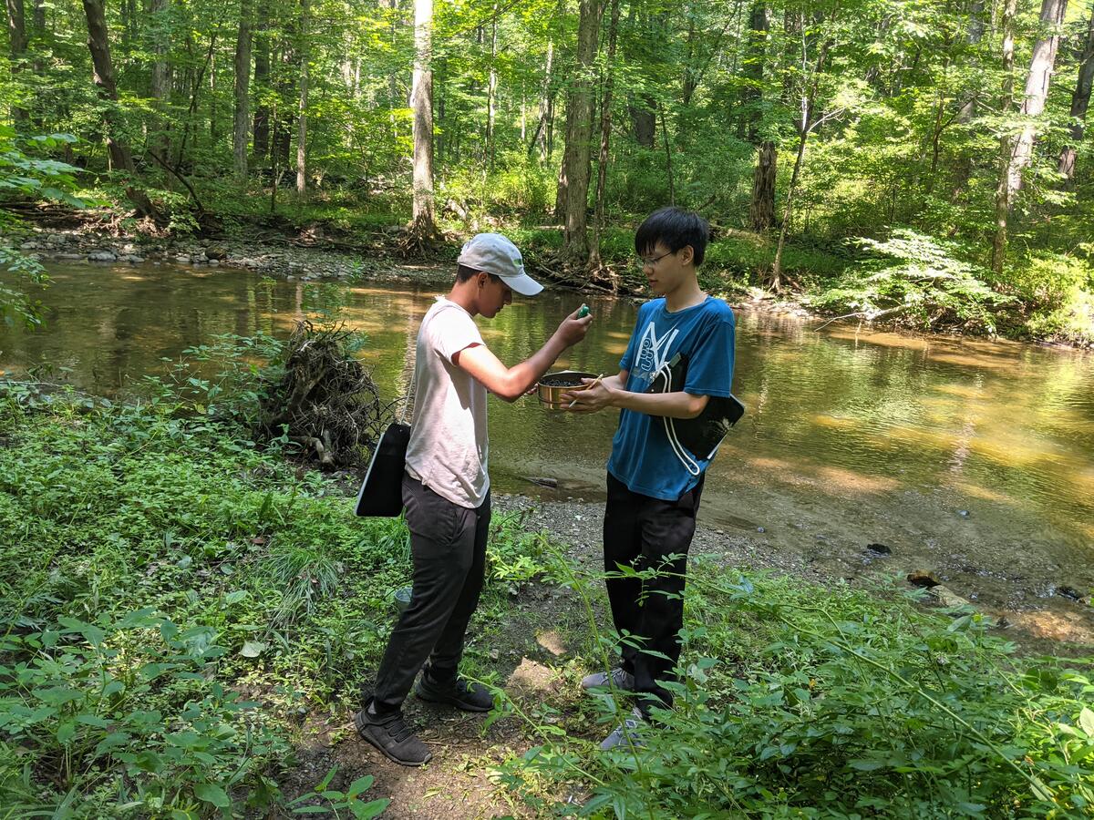 Two MH-YES high school students collect soil samples on the banks of the Wappinger Creek in Millbrook, New York.