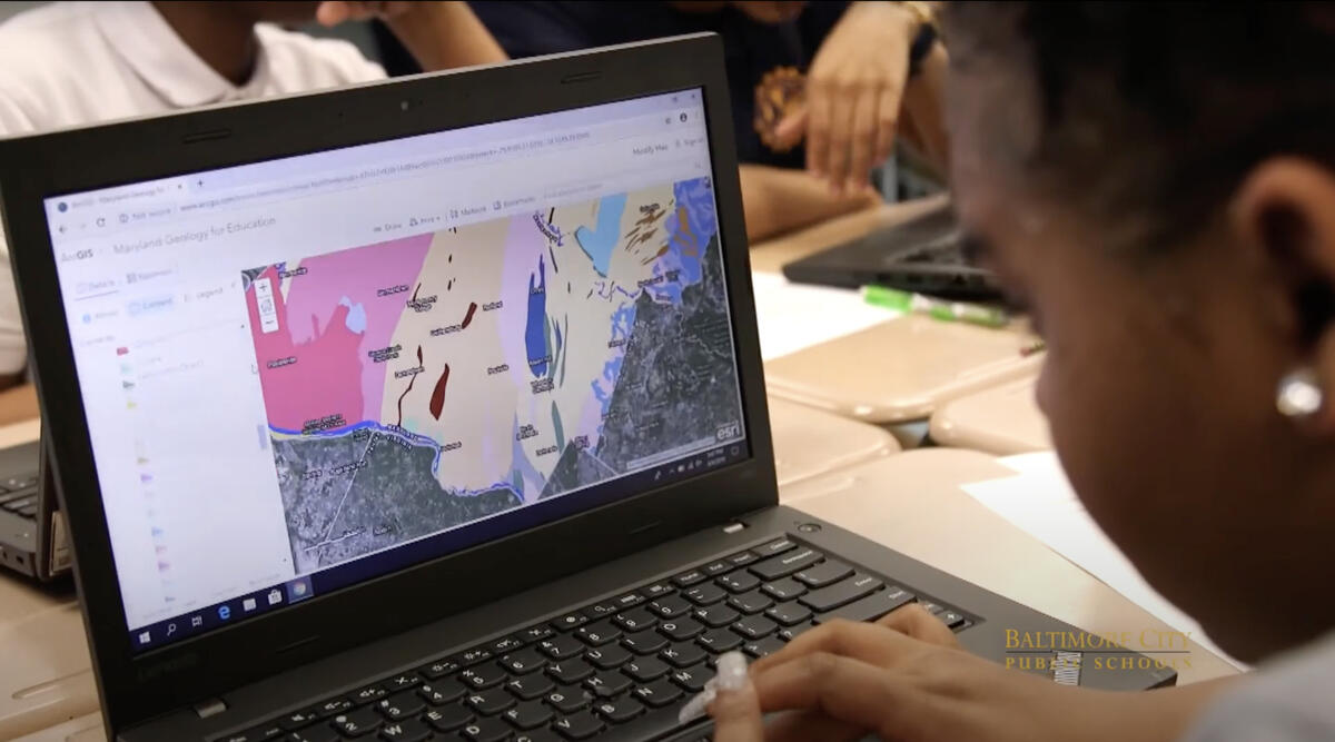 baltimore student looking at a map on a computer