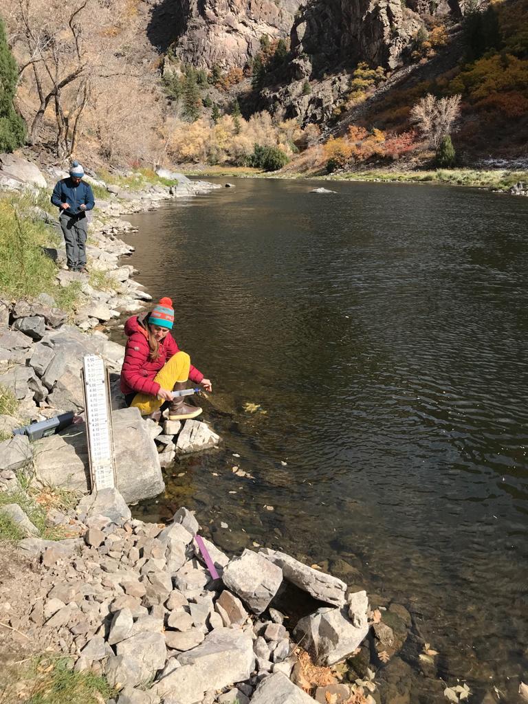 scientists near a river
