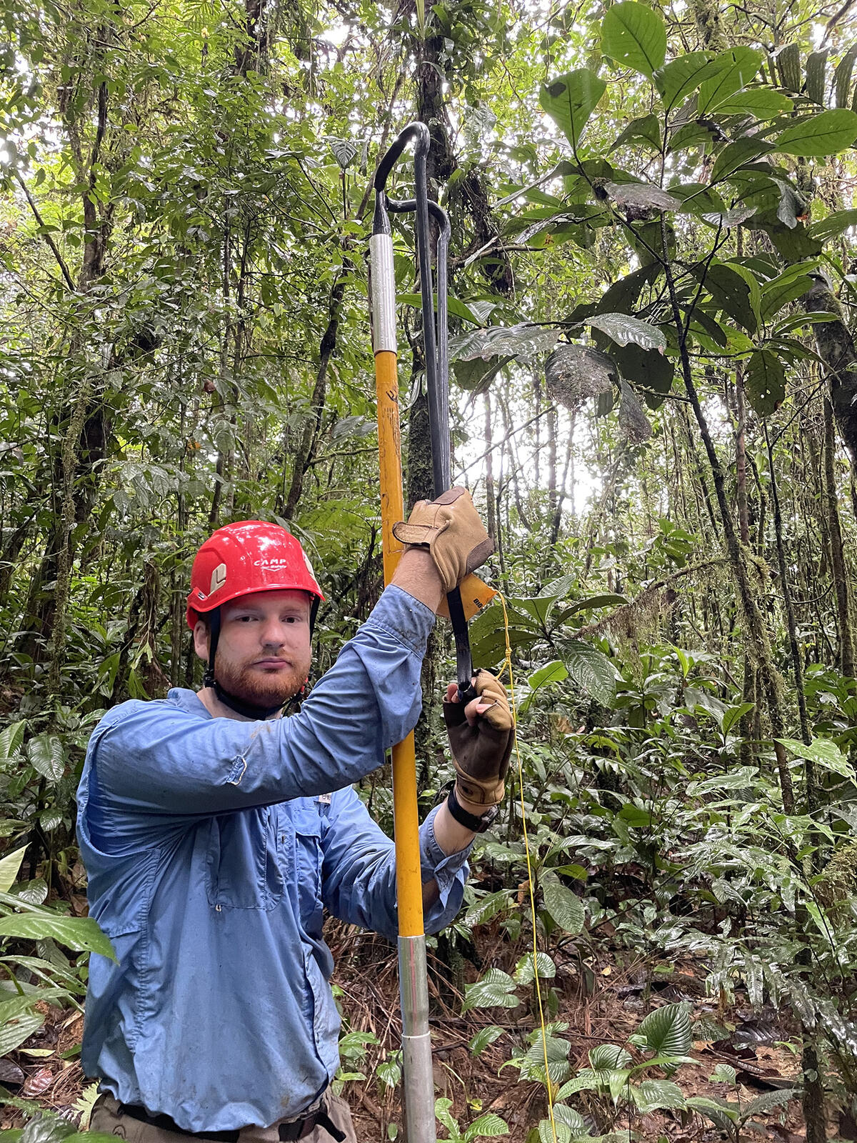 Matthew Gano next to a large yellow pole