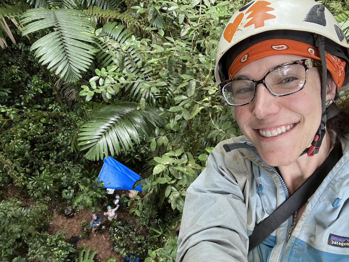 Michelle Elise Spicer in helmet climbing a tree
