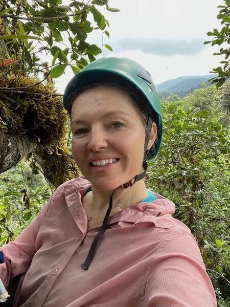 headshot of Jane Lucas in a tree canopy and climbing helmet